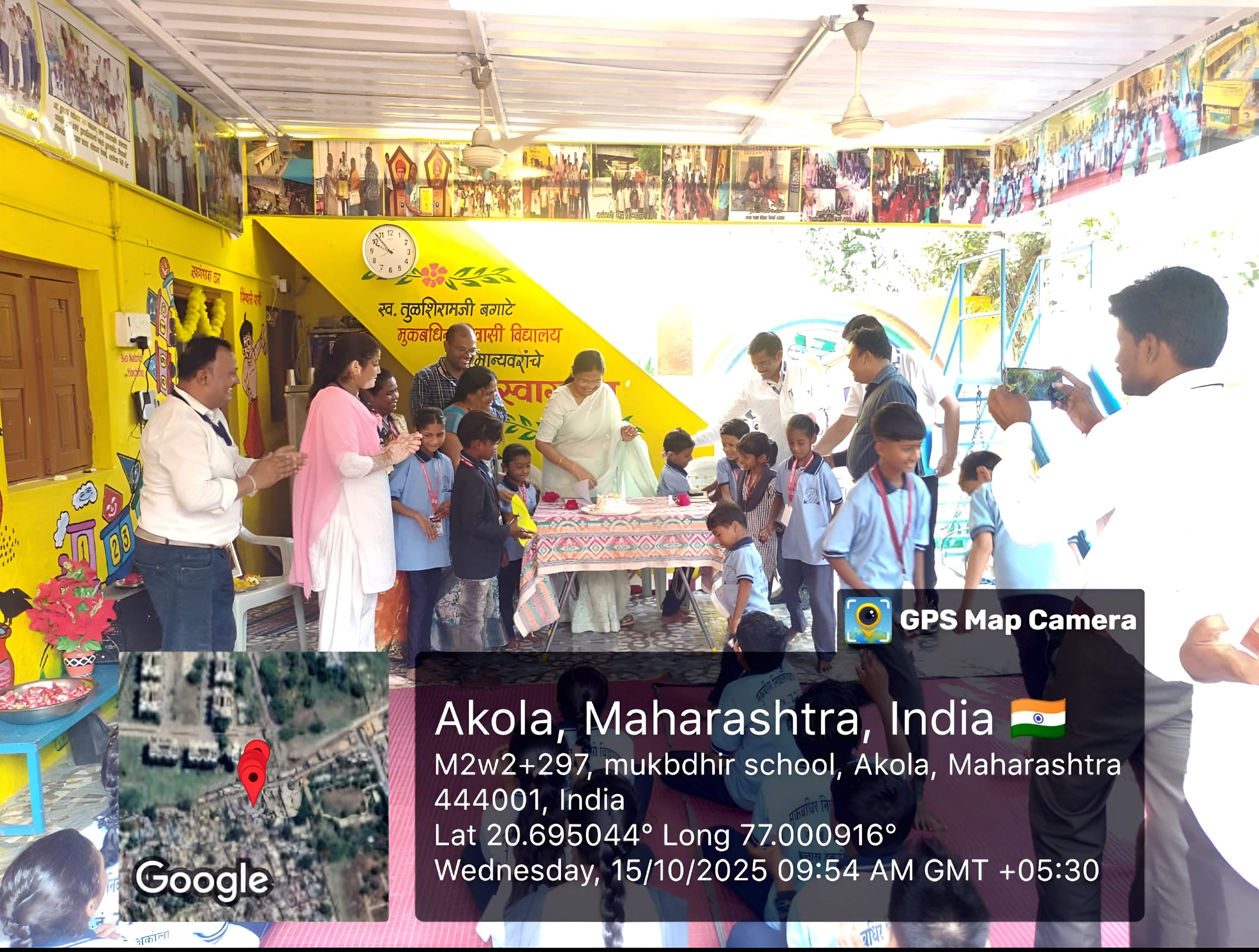 Students and guests celebrating by cutting a cake at a school event